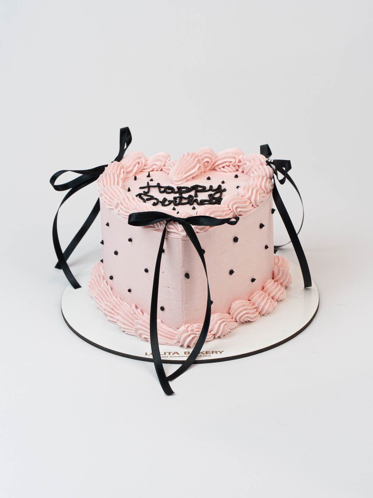 Pastel corazon rosa con topos y lazos negros - Lolita Bakery